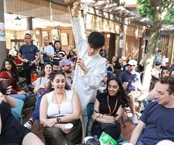 A group of Kellogg students participating in a cultural demonstration during a trip to China