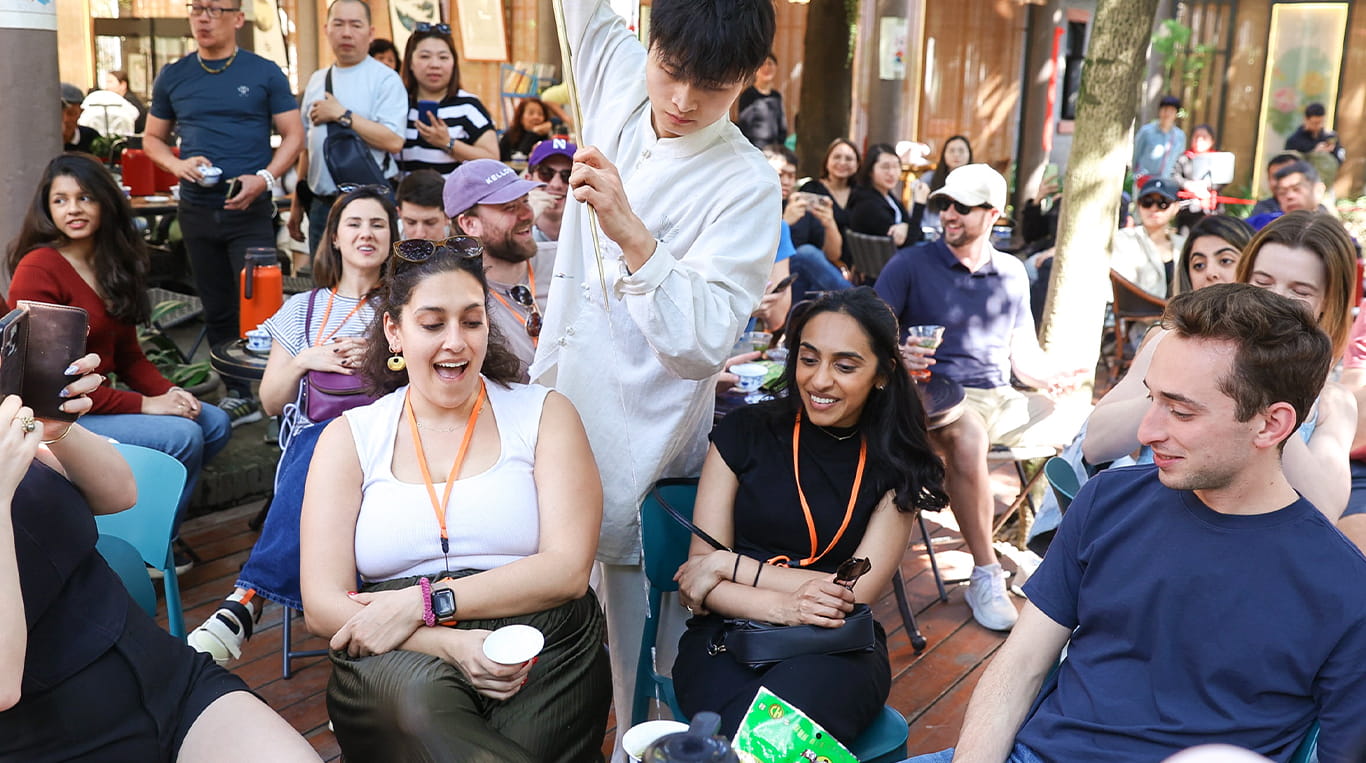 A group of Kellogg students participating in a cultural demonstration during a trip to China