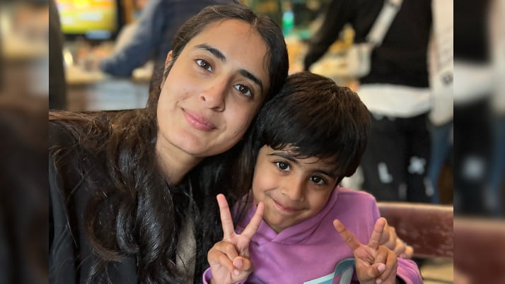A woman sitting next to her son