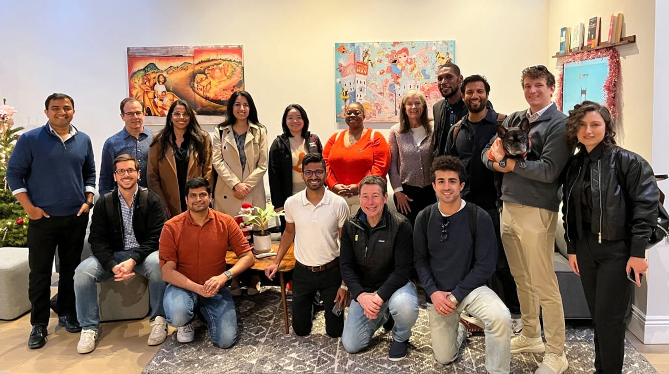 A group of Kellogg students smile and pose together near colorful artwork, while on a Levy Trek in San Francisco to learn about AI and entrepreneurship.