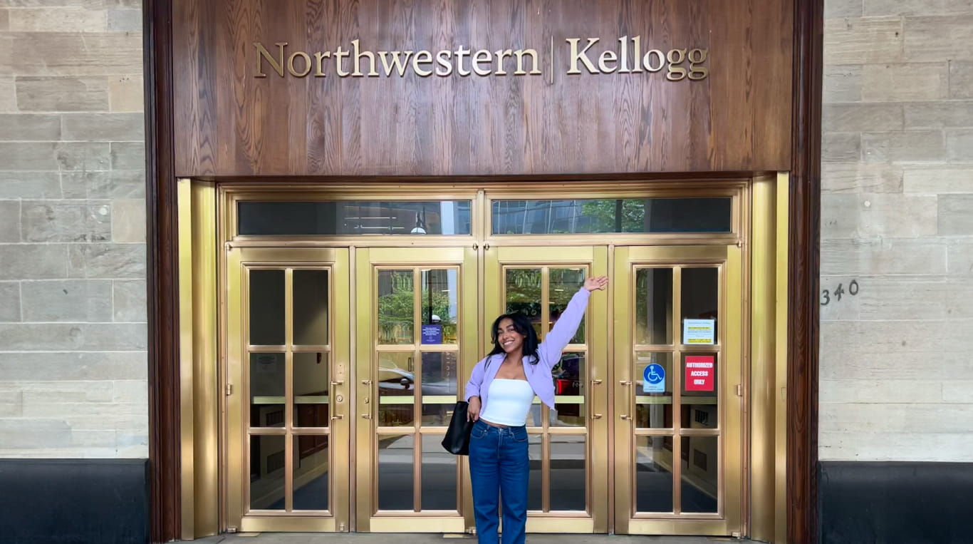 A Kellogg alumna posing in front of a building