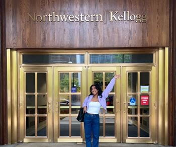 A Kellogg alumna in front of one of the school's buildings
