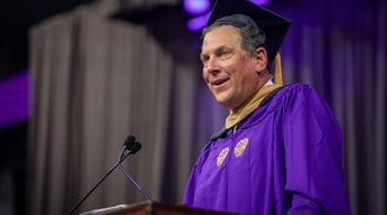 Keynote speaker John Schlifske ’83 MBA, chairman and former CEO of Northwestern Mutual, speaks from a podium at the 2025 Kellogg Convocation.