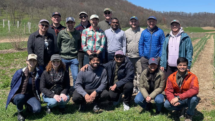 A group of MBA students learning about regen ag in an immersive learning trip