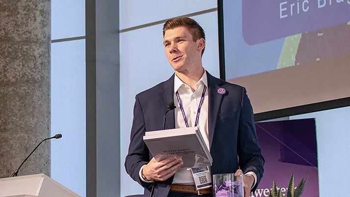 Eric Bragg, a Kellogg MBA graduate, addressing the crowd during the Climate Conference.