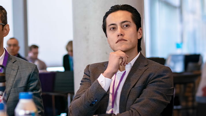 Sergio Monroy sitting in a chair during the Climate Conference held at the Global Hub.