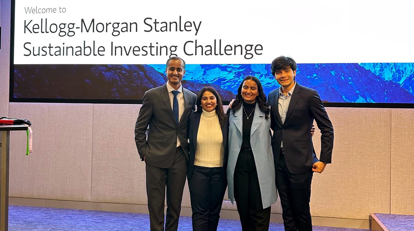 Two men and two women standing in a classroom
