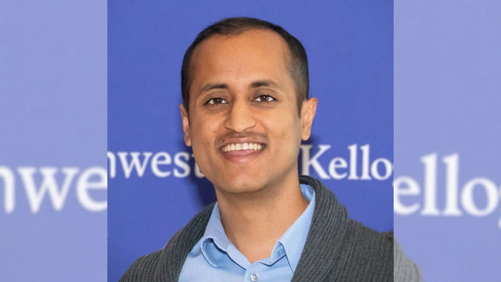 A man wearing a blue collared button down shirt