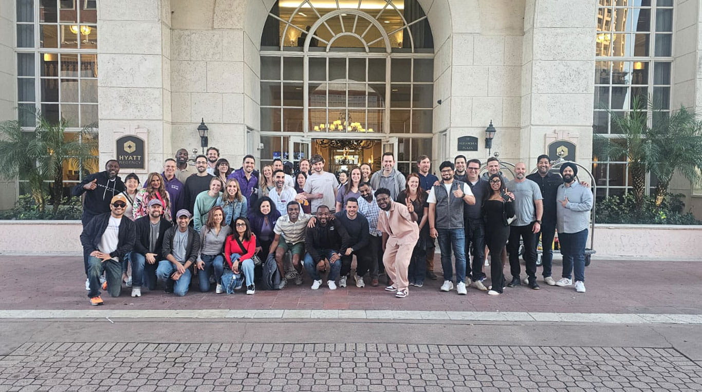 A group of people standing outside in front of a building