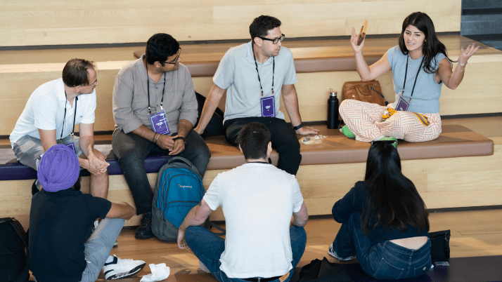 A group of Kellogg MBA students listening to another student share her thoughts.