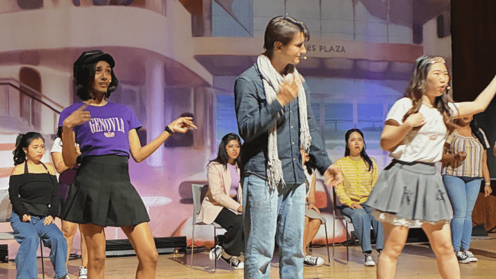 MBA students on stage performing in a musical comedy show