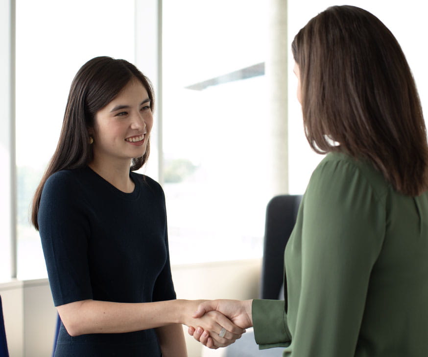 Two women shaking hands