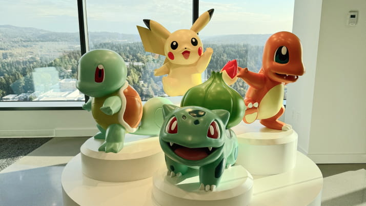 Four large figurines resting on an elevated platform