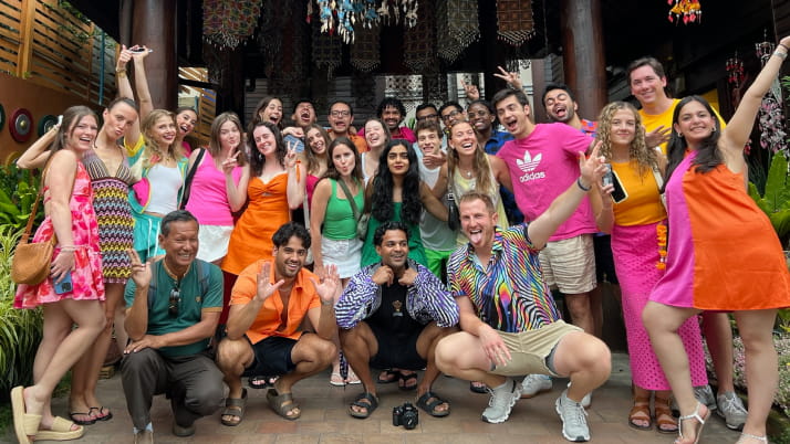 A group of men and women wearing brightly colored attire