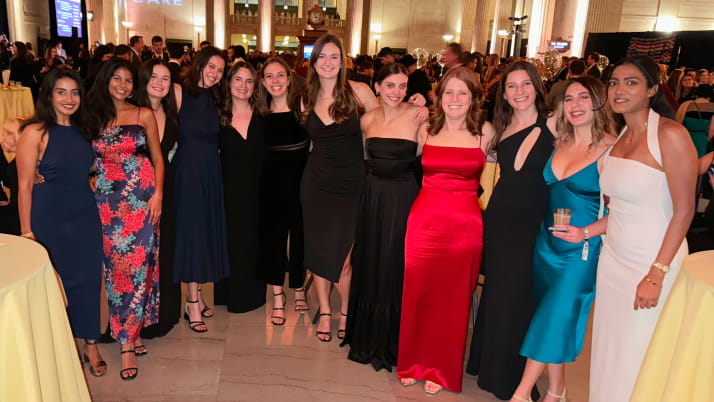 A group of women wearing cocktail dresses