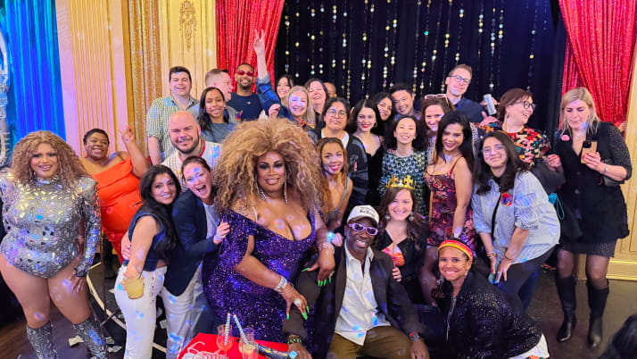 A group of men and women at a drag show.