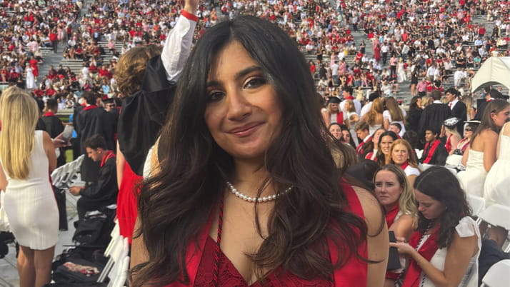 A young woman with long, dark hair wearing a red dress