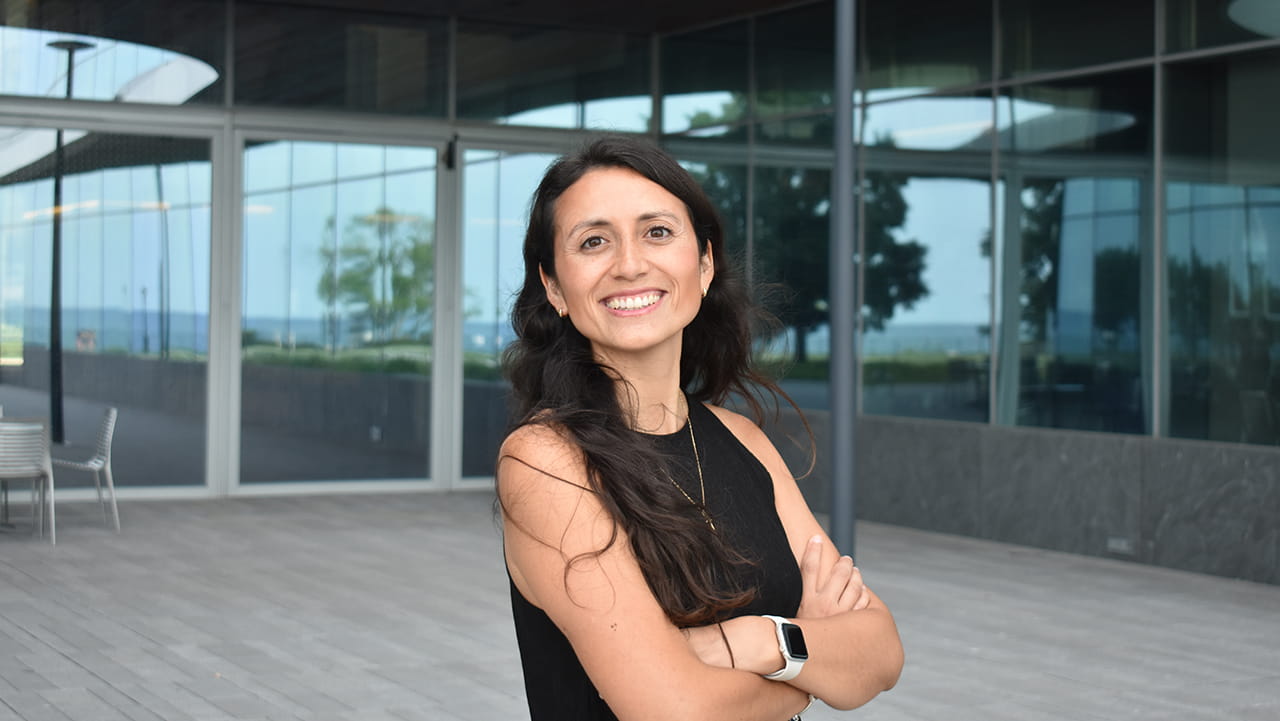 A woman stands in front of a building