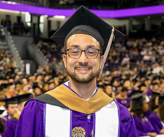 Ryan Ghosh in cap and gown at Kellogg graduation.
