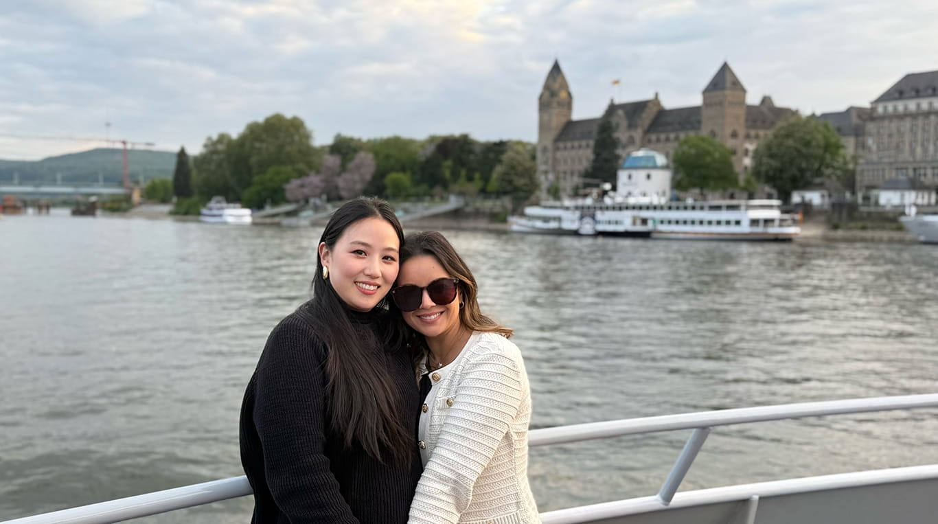  Gina Baeg and Katrina Mercado stand along a river's edge.