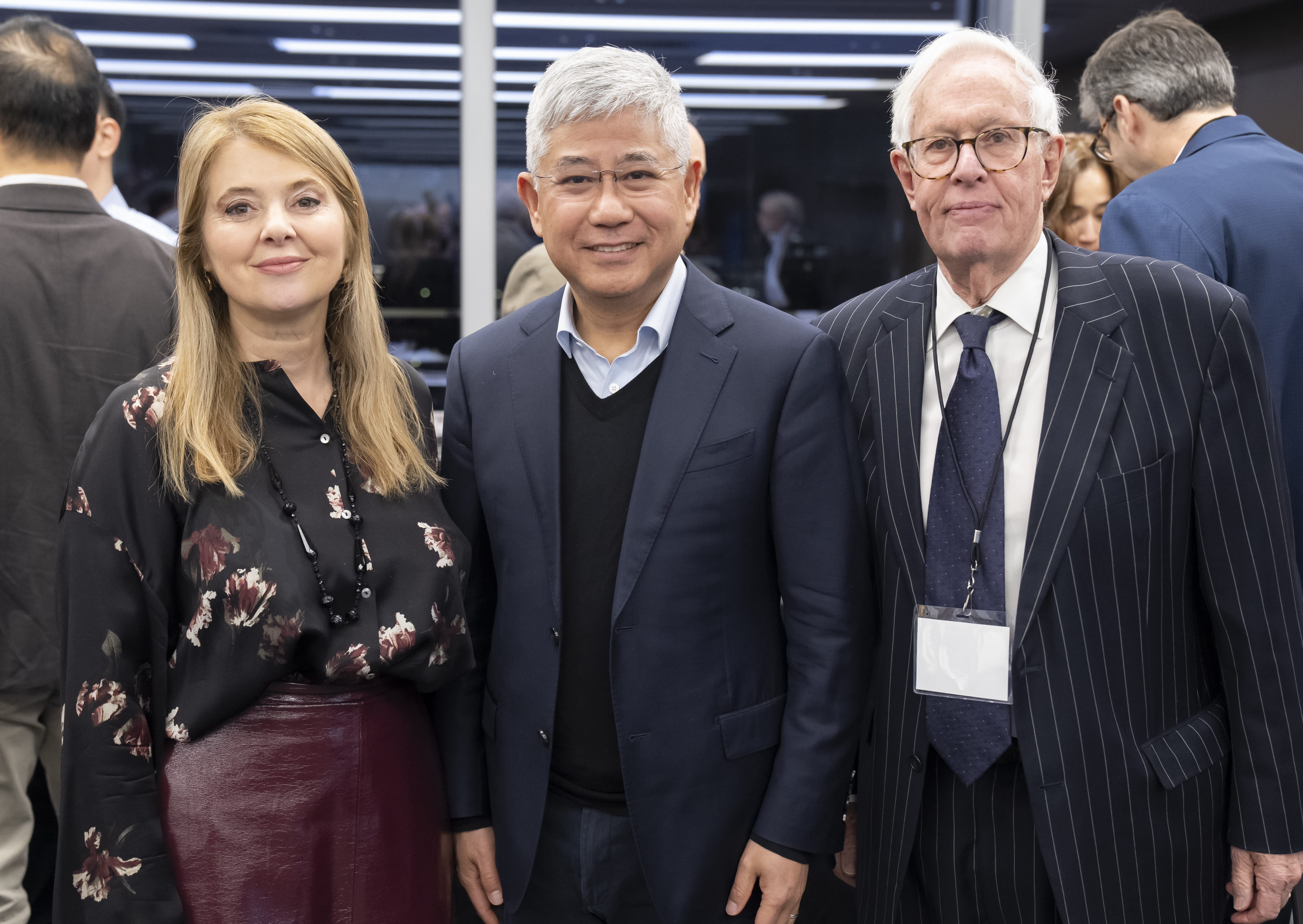 A woman and two men standing