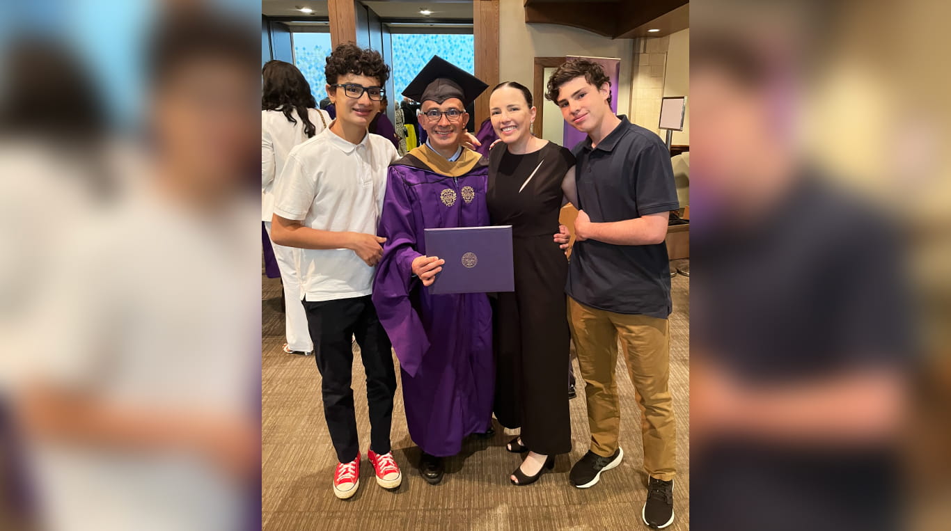 A man and a woman in between two boys at opposite ends.