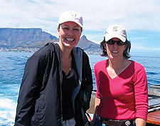 Katherine McCormick '96 and Carla Johnson Ravipati '96 in South Africa on the Robin Island Ferry with Table Mountain in the background.
