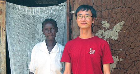 Andrew Youn '06, right, with a farmer served by One Acre Fund