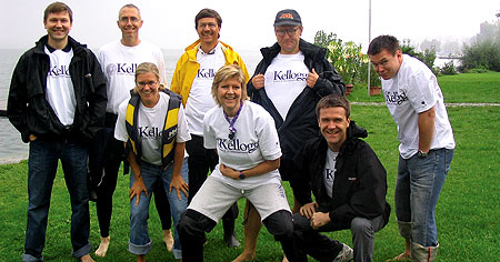 They're all wet: Members of the Swiss alumni club show their Kellogg pride after winning a rainy-day boat race in September.