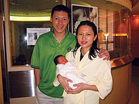 Katherine Sung '03 and her husband with their new child, Caitlin Leung.