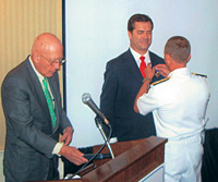 Admiral Eric Olson, commander of U.S. Special Operations Command, presents Captain Dan Rice '00 with the Purple Heart